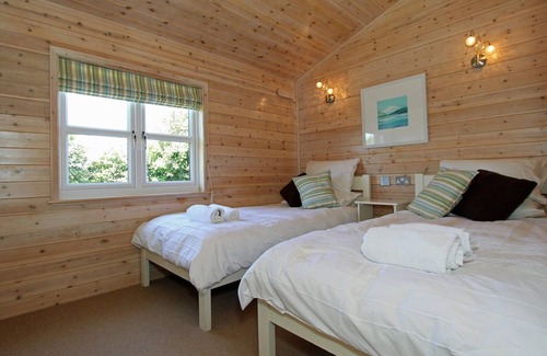 St Merryn Cabin | A light and spacious lodge with one double with walk in wardrobe and en-suite shower and one twin.