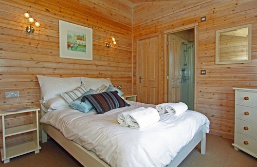 St Merryn Cabin | A light and spacious lodge with one double with walk in wardrobe and en-suite shower and one twin.