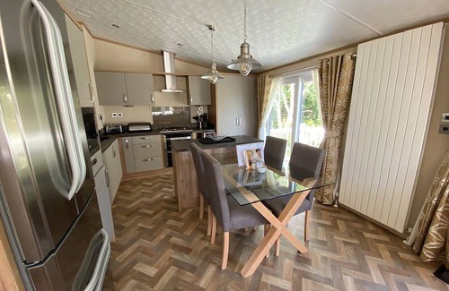 Langham House | A stunning lodge with one master double with en suite with bath and overhead shower.
