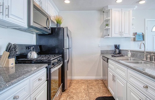 West Newport Condo | Amazing location with an amazing, newly-remodeled lower unit right on the sand!