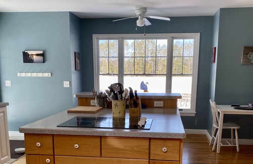 Gwinn Cottage | Beach front lake home, sleeps 8, hot tub, lots of outdoor spaces, docks.