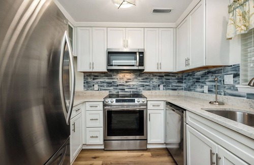Caswell Beach Condo | By The Ocean Blue: Oceanfront Luxury on Caswell Beach with Community Pool
