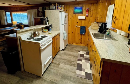 Cedar Cottage | Charming lake house combines rustic ambiance with modern amenities.