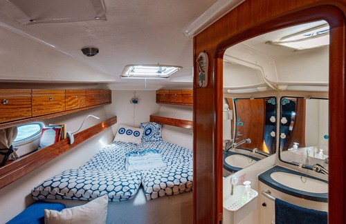 Bari City Centre Boat Rental | Charming sailing boat - in front of the city skyline