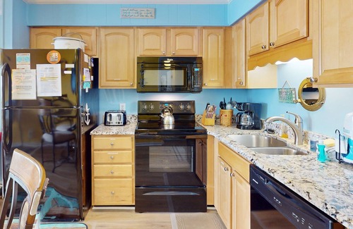 Ocean Isle Beach Condo | Colorful ocean view condo with pool, central AC, & private washer/dryer