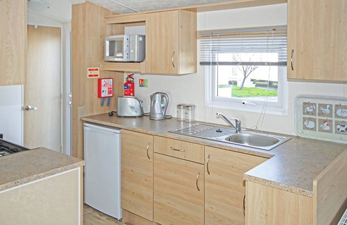 Gwespyr House | Comfortable 12ft-wide caravan with one double and one twin.