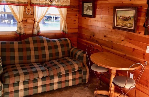 Coeur d'Alene Cabin | Cowboy Cabin - porch, queen bed, old-fashioned water pump in kitchen