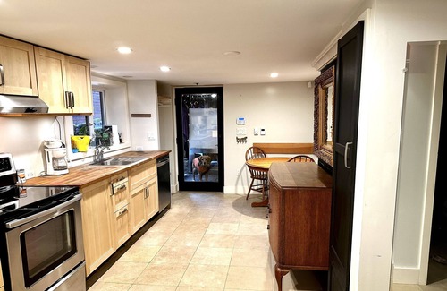 Grandview-Woodland House | Cozy Garden level suite with heated floors. 1 block off “The Drive”.