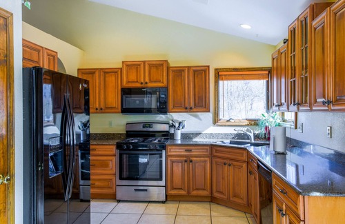 Whittier House | Creek-side home with private hot tub, game room, firepit, deck & mountain view