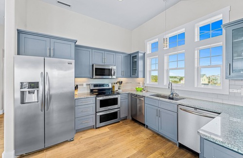 Salvo House | Dazzling waterfront home with balconies, private pool, hot tub, & game room