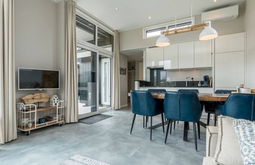Burgh-Haamstede House | Discover this beautiful L-shaped chalet with a covered, sheltered terrace and a lovely lounge set. T