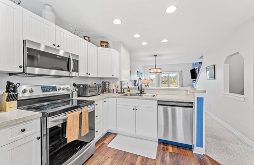 Bermuda Bay House | Dog-friendly townhouse with private hot tub, game room, pool, gym, & beach gear