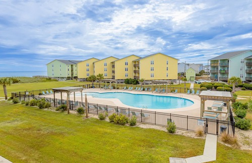 Surf City Condo | Dreamy beach condo with pool, easy beach access & furnished balcony with views