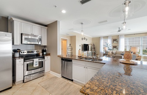 Upper Grand Lagoon Condo | Elegant Fourth Floor Condo with Shared Pool & Hot Tub, Ocean View, and WiFi