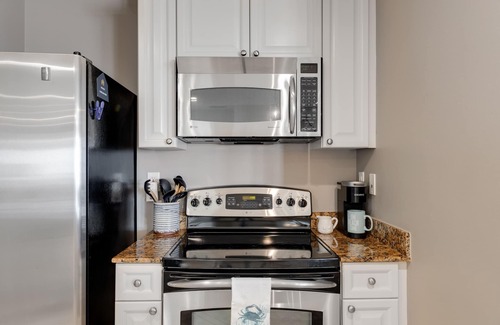 Upper Grand Lagoon Condo | Elegant Fourth Floor Condo with Shared Pool & Hot Tub, Ocean View, and WiFi