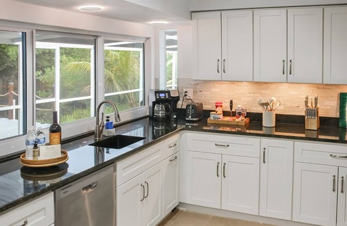 Fort Myers House | Enjoy a stunning waterfront view, pool table,kayaks, fishing, BBQ, heated & pool