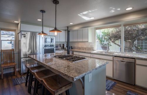 Roads End House | Enjoy the waves in the hot tub at this beachfront home with direct beach access