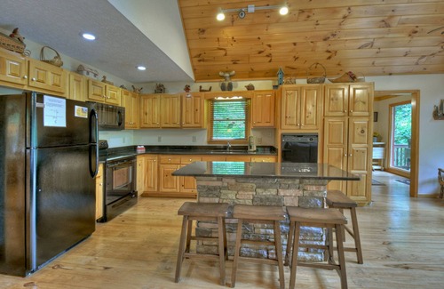 Walnut Mountain Cabin | Experience Lakeview Retreat, where pets are pampered by the shimmering waters. Unwind in a hot tub, enjoy WiFi, and a full game room w/pool table