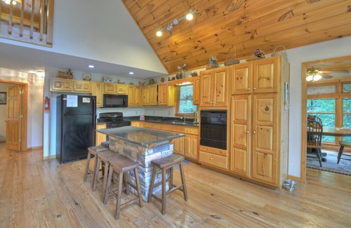 Walnut Mountain Cabin | Experience Lakeview Retreat, where pets are pampered by the shimmering waters. Unwind in a hot tub, enjoy WiFi, and a full game room w/pool table