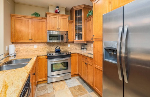 Big White Ski Resort Condo | Family sized cozy ski-in/ski-out retreat w/hot tub and stunning mountain views