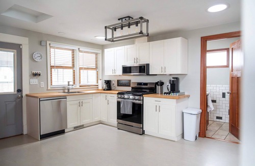 Midway House | Follow the Yellow Front Door to a welcoming home close to everything.