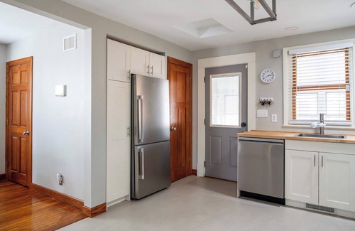 Midway House | Follow the Yellow Front Door to a welcoming home close to everything.