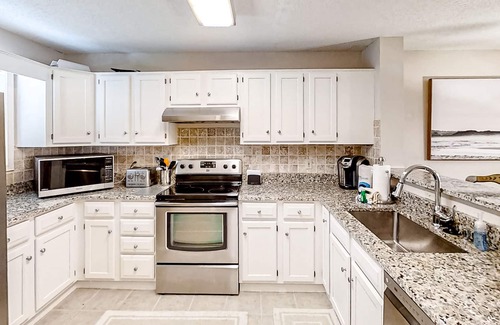 Colonial Charters Condo | Golf course community condo with fairway views, on-site pool, & balcony