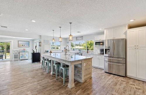 Cocoa Isles House | Gorgeous Private Canal Home w/Heated Pool, Hot Tub & Modern Kitchen - Walk to Restaurants!