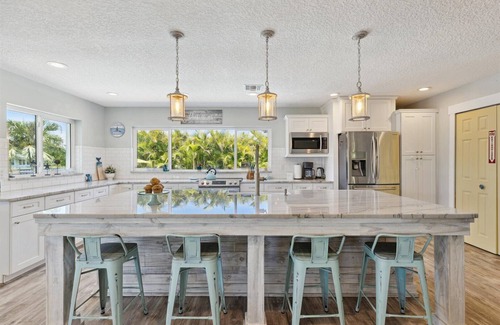 Cocoa Isles House | Gorgeous Private Canal Home w/Heated Pool, Hot Tub & Modern Kitchen - Walk to Restaurants!