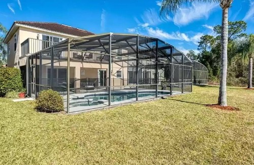 Lake Wilson Preserve House | Gorgeous water view from South facing pool deck. Balcony off upstairs master bed