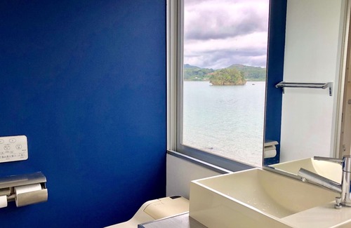 Nago Apartment | Indigo Ocean front Large windows overlook the se / Nago Okinawa