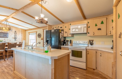 Polson House | Inviting lake view home with fireplace, golf nearby, full kitchen, & W/D