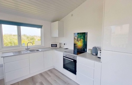 Hayle Apartment | Irene sits amongst the dunes, just a short walk to the three miles of golden, sandy beach below