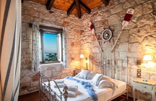 Psarou Villa | Kavos Psarou stone and wooden built sea front sea view traditional/lux villa