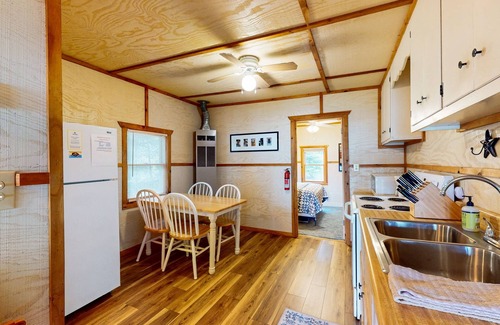 Eagle River House | Lakefront cottage w/a dock, shared furnished patio, firepit, & a paddleboat