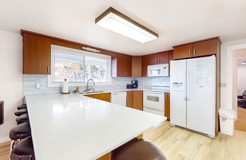 Laketown House | Lakefront east side home on private beach with mountain view & large grassy yard