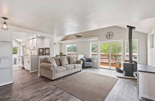 Sagle House | Lakefront home with tiki bar, private dock, hot tub, decks, fire pit, & kayaks