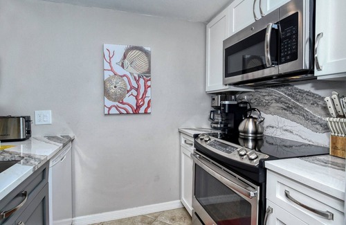 Longboat Key Apartment | LaPlaya 202E-Catch the gentle Gulf breezes on your private balcony beneath the swaying palms.