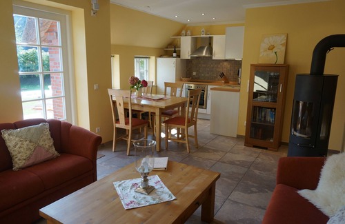 Nebel Apartment | Living in a modern thatched house in fog with a fireplace and sauna