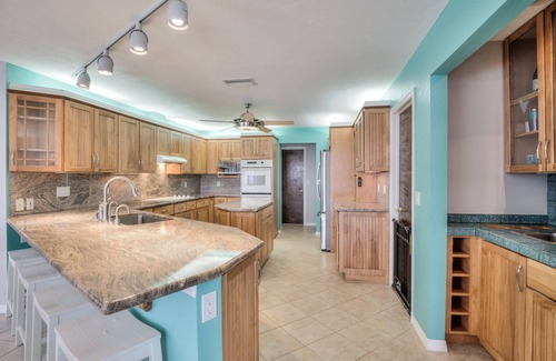 Yacht Club House | Lovely Canal Home in SW Cape with heated pool, game room, and a tiki on the dock