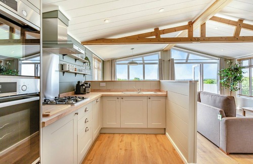 Middlezoy Ski Chalet | Luxurious lodge with vaulted ceilings and a welcoming feature fireplace.