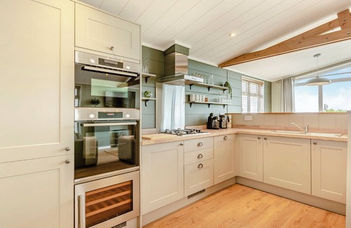 Middlezoy Ski Chalet | Luxurious lodge with vaulted ceilings and a welcoming feature fireplace.