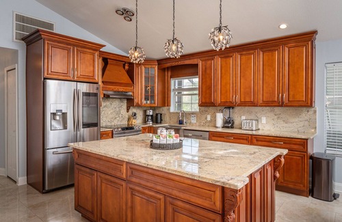 Dunedin House | Luxury 5 Bedroom Dunedin home ~ TWO full kitchens, heated pool, hot tub!