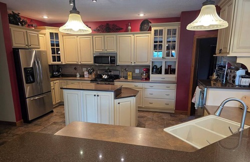 Geneseo House | Luxury 5 BR home on private wooded lot near QC, w/hot tub, rec & fitness room