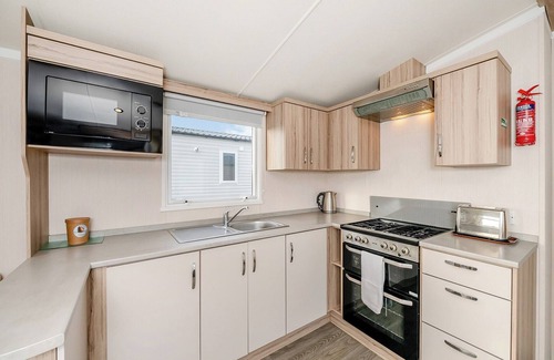 Otterton House | Modern and spacious 12ft-wide caravan with one double and two twin.