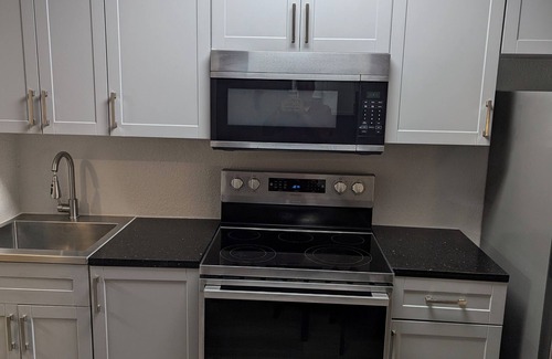 Kissimmee Apartment | Modern one-room apartment with updated amenities, including a full kitchen.