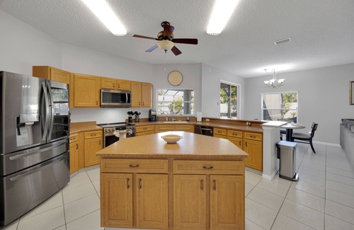 Palm Harbor House | Modern Poolside Getaway w Games, Fire pit & Family Fun