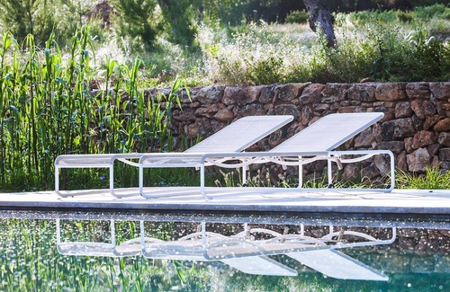 Santa Eulalia del Rio Villa | My Rental Homes - Villa Cave covered veranda with dining room and pool.