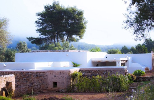 Santa Eulalia del Rio Villa | My Rental Homes - Villa Cave covered veranda with dining room and pool.