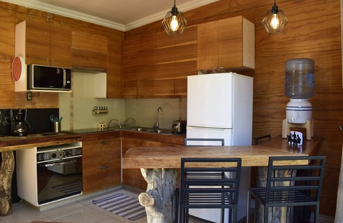 Lo Barnechea House | Ñilhue house with forest and river